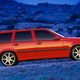 A sporty red Volvo 850 R station wagon in a field